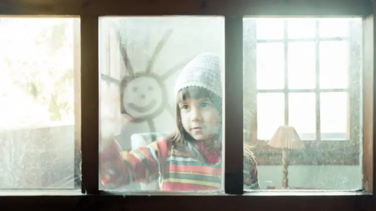 Child looking out a window